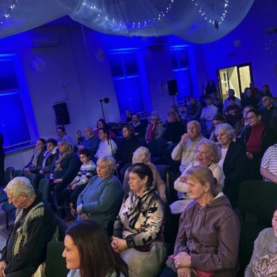 Ludzie siedzący na widowni podczas koncertu.