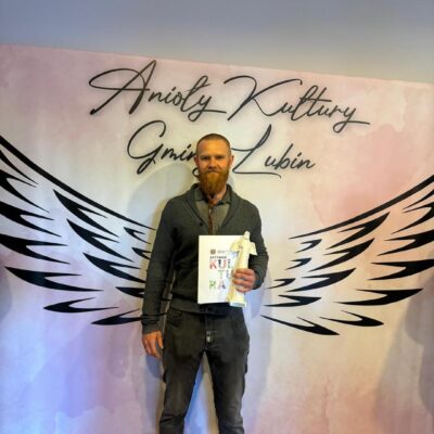 Laureat na ściance pozuje do zdjęć.