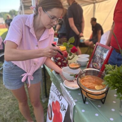 Sołtys Edyta Szymańska nalewa zupę dla jury.