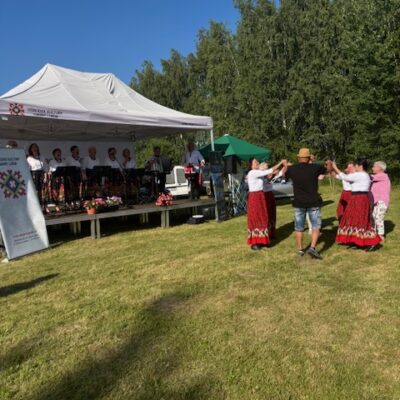 Kobiety z koła tańczą z sołtysem pod sceną.