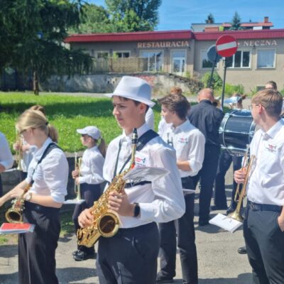 Muzycy w korowodzie jeden za drugim idą i grają