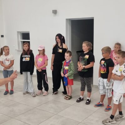 dzieci stoją i słuchają instruktora