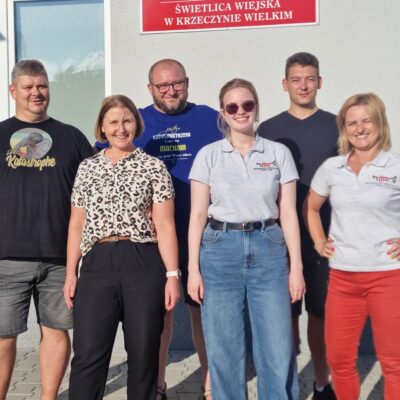 grupa instruktorów i organizatorów przed salą pozują do zdjęcia