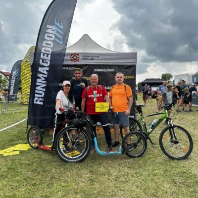 Zawodnicy z rowerami na ściance do zdjęć